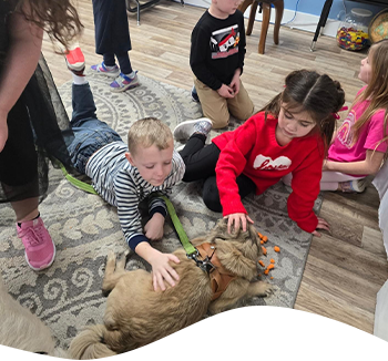 little kids petting a puppy