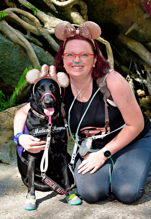 Woman and her dog wearing Mickey Mouse ears